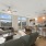 living room with large windows and ceiling fan