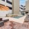 Large sparkling blue pool with a large pool deck and lounge chairs